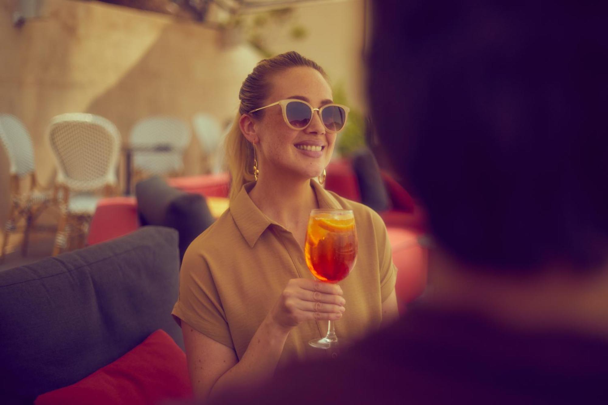 Secrets Mallorca Villamil Resort & Spa - Adults Only Пагера Екстериор снимка A woman drinking an Aperol Spritz